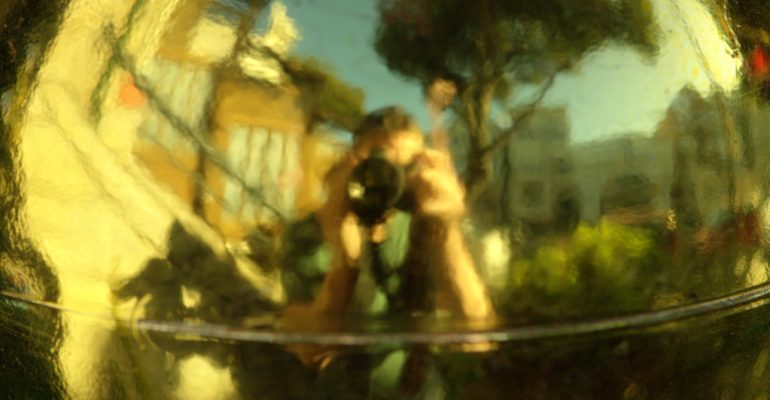 Abstract reflection of a person taking a photo, symbolizing introspection and self-awareness.