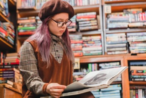 teen reading in a library - reflection and bibliotherapy for odd girl out