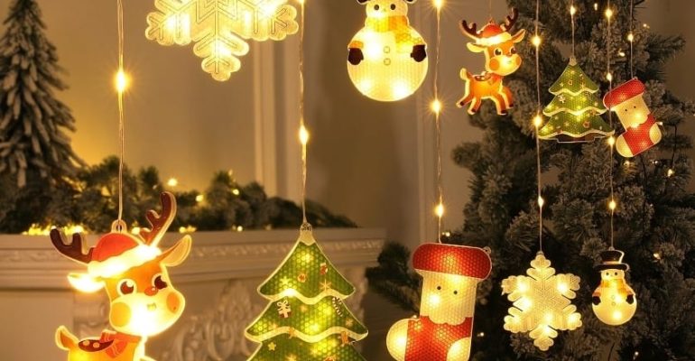 Warm Christmas lights shaped like snowflakes, trees, and holiday figures hanging near a decorated tree, creating a calm and reflective holiday atmosphere.