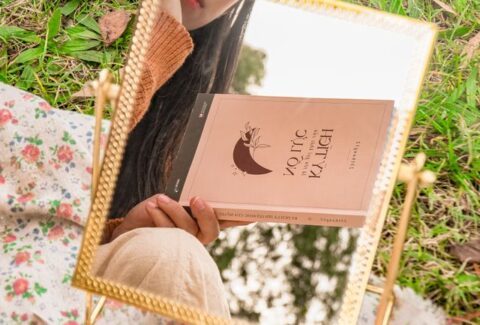 Open book with a warm, reflective setting symbolizing self-discovery and finding your way back to yourself.
